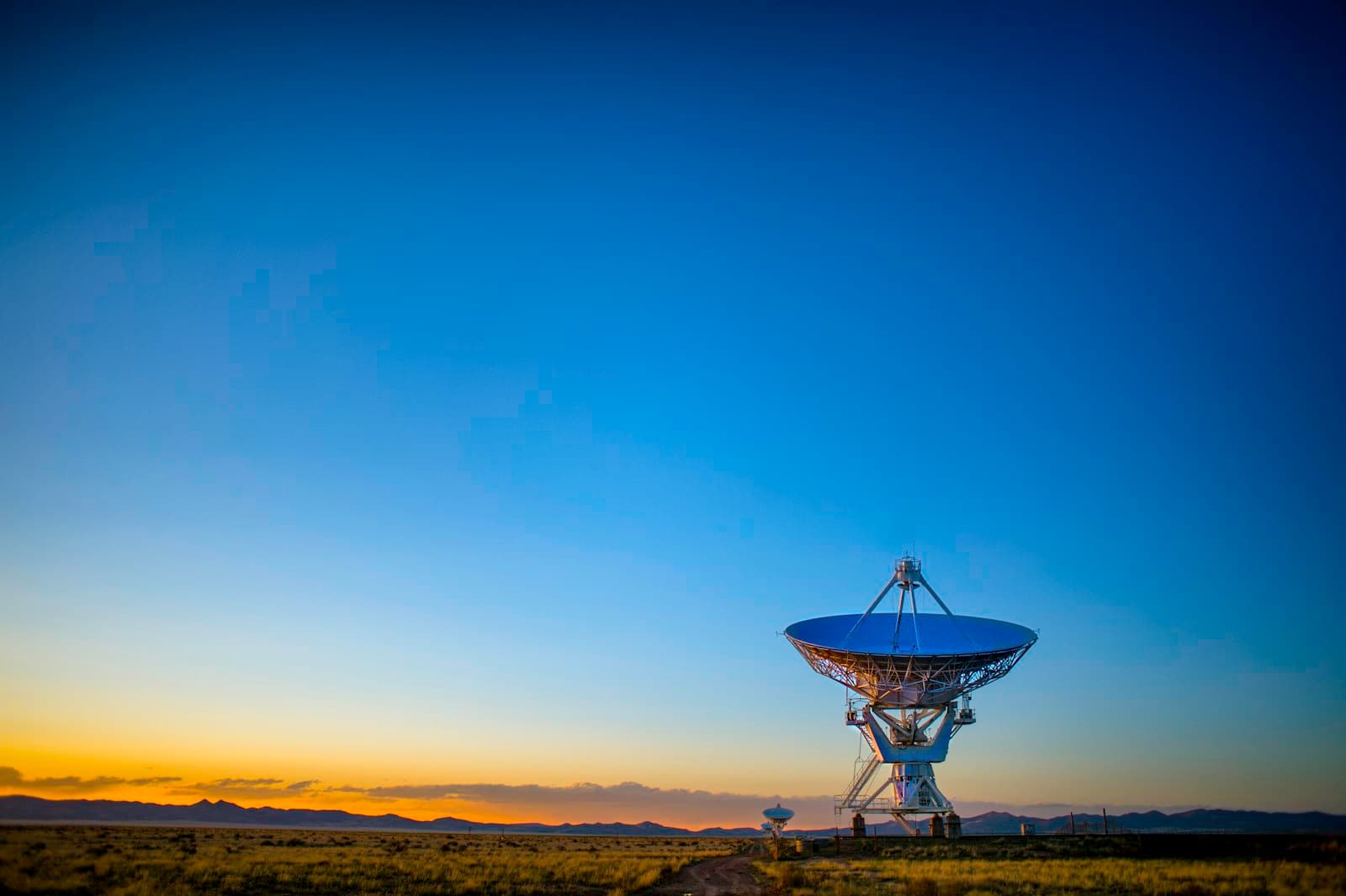 Satellite communications dish under an open sky.